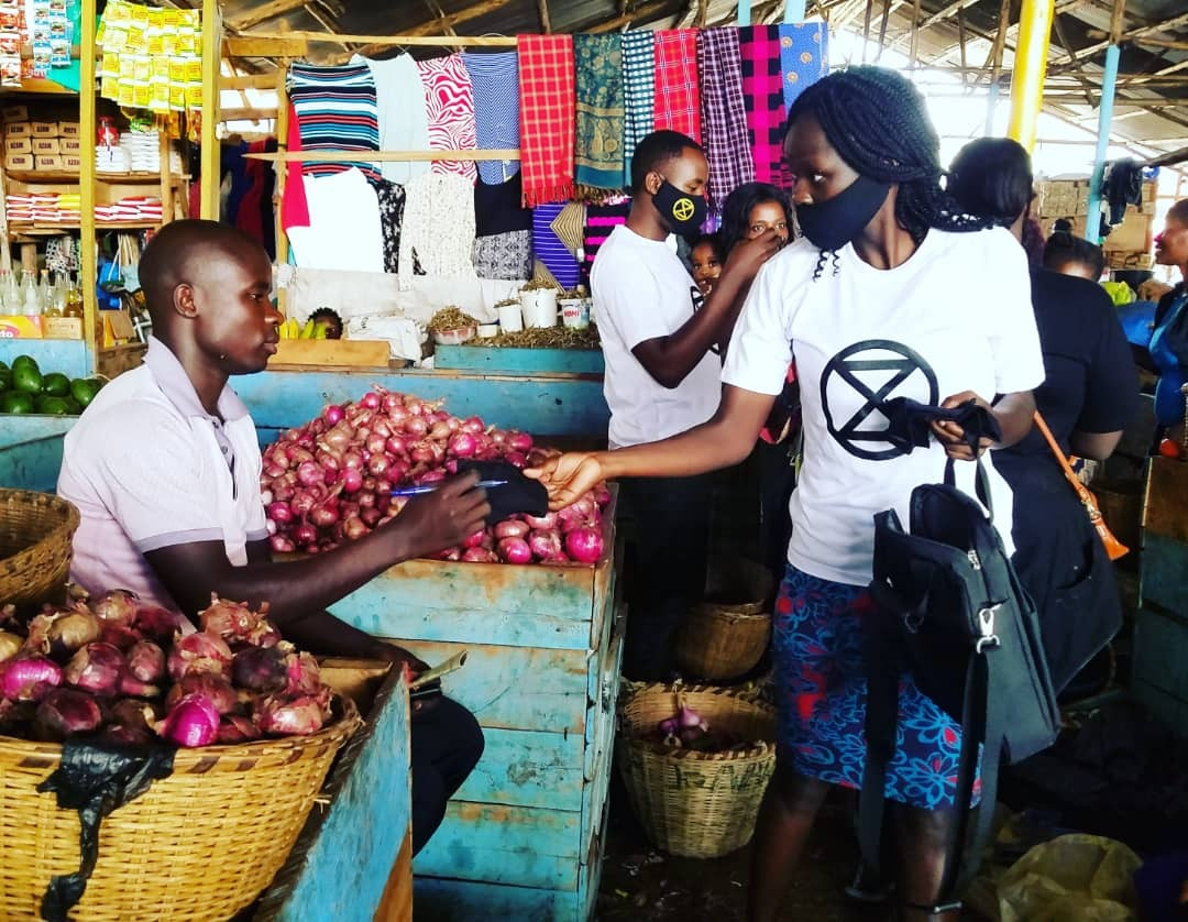 Rebels in Kampala hand out face masks and soap to market vendors.