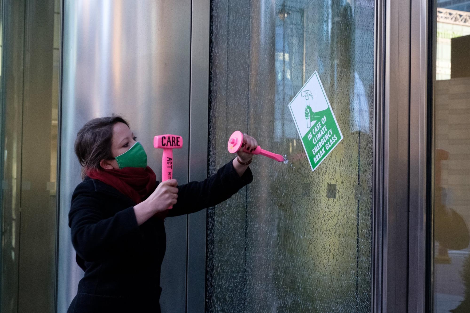 London, UK. 7 women rebels break windows of Barclays HQ, the 7th dirtiest bank, inspired by the suffragettes who broke windows in their fight to win women the vote.