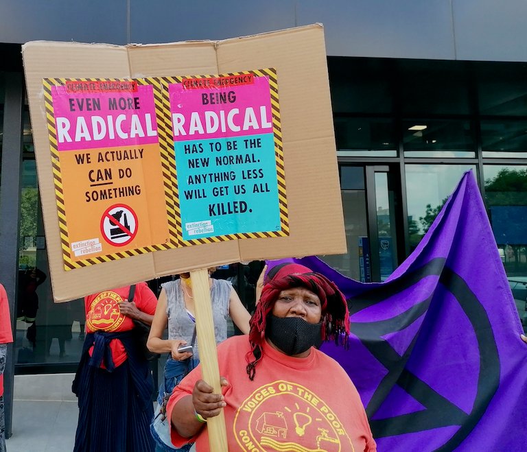 A rebel pickets Standard Bank’s offices in Johannesburg Zoe Postman